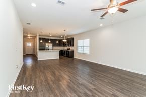 Jacksonville house for rent - A spacious room with a ceiling fan and wooden flooring.