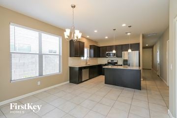 San Tan Valley house for rent - a kitchen with a large window and an island with a sink