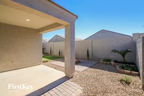 San Tan Valley house for rent - a walkway into a home with a wall and a patio