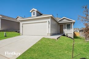 San Antonio house for rent - a home with a white garage door and a sidewalk