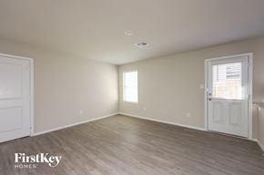 San Antonio house for rent - an empty bedroom with a white door and wood flooring