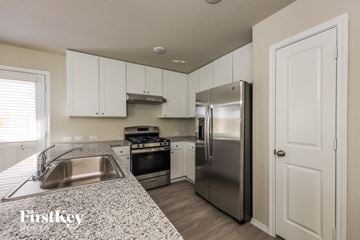 San Antonio house for rent - a kitchen with stainless steel appliances and granite counter tops