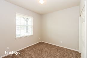 Baytown house for rent - a bedroom with a carpeted floor and a window