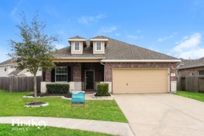 Baytown house for rent - a home with a driveway and a garage door