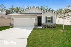 Jacksonville house for rent - a white house with a lawn and a driveway