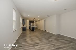 Jacksonville house for rent - a spacious living room with white walls and wood flooring