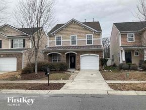 Charlotte house for rent - a brick house with a white garage door