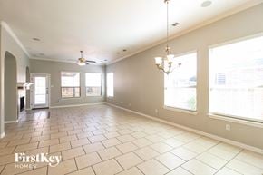 Little Elm house for rent - a dining room and living room with large windows and tiled flooring