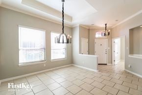 Little Elm house for rent - an empty dining room with two windows and a white door