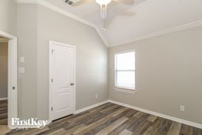 Little Elm house for rent - a bedroom with a white door and a ceiling fan