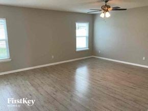 Middleburg house for rent - an empty living room with wood floors and a ceiling fan