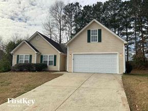 Dacula house for rent - a house with a white garage door and a driveway