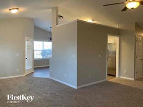 Dacula house for rent - an empty living room with a ceiling fan
