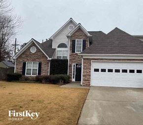 Kennesaw house for rent - a brick house with a white garage door