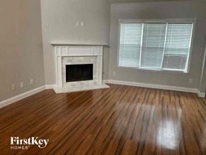 Kennesaw house for rent - a living room with a fireplace and wooden floors
