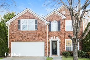 Canton house for rent - A brick house with a white garage door and a black front door.