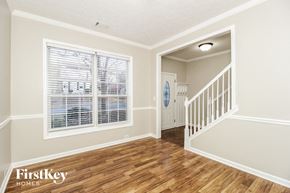 Canton house for rent - A room with wooden floors and a staircase leading to another room.