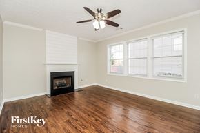 Canton house for rent - A room with a fireplace and a ceiling fan.
