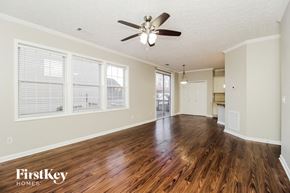 Canton house for rent - A spacious room with wooden floors and a ceiling fan.