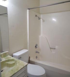 Hattiesburg apartment for rent - A white toilet sits next to a sink in a bathroom.
