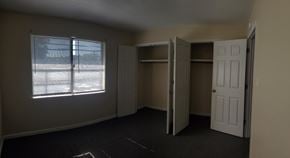 Hattiesburg apartment for rent - A room with a window, two closets, and a door.