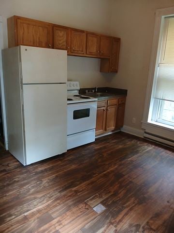 Louisville apartment for rent - a kitchen with a refrigerator and a stove and wooden floors