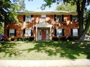 Louisville apartment for rent - A red brick house with a white door and windows.