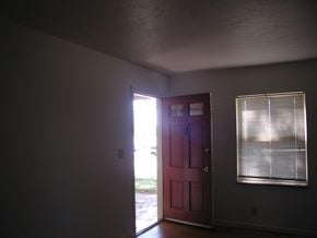 Louisville apartment for rent - A red door is open to a hallway.