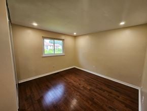 Toronto house for rent - A room with wooden floors and a window.