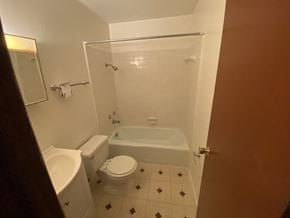 Hattiesburg house for rent - a small bathroom with a toilet and a bath tub
