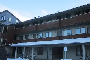 Frisco apartment for rent - A building with a brown and beige facade has a white awning.