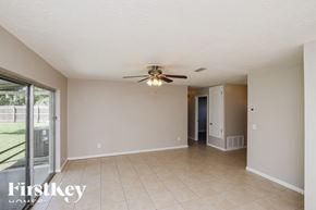 Rockledge house for rent - A spacious room with a ceiling fan and sliding glass doors.