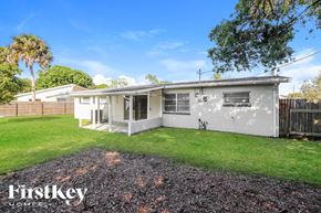 Rockledge house for rent - A house with a gravel driveway and a grassy lawn.