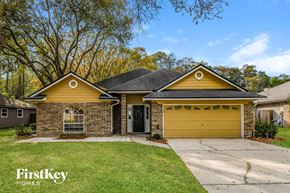 Jacksonville house for rent - a yellow brick house with a yellow garage door