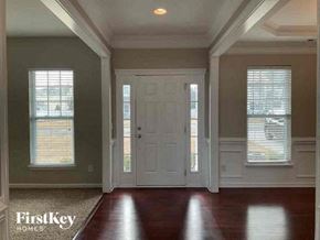 Concord house for rent - an empty living room with a white door and windows