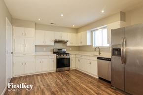 Phoenix house for rent - A kitchen with wooden floors and stainless steel appliances.