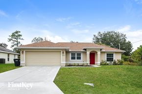 North Port house for rent - a beige house with a red door