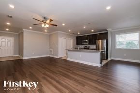 Spring Hill house for rent - A spacious kitchen and living room with wooden floors and a ceiling fan.