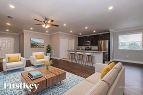 Spring Hill house for rent - A living room with a white couch, a coffee table, and a ceiling fan.
