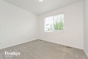 Mead house for rent - a bedroom with white walls and a window