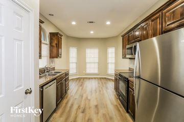 Weatherford house for rent - A modern kitchen with wooden cabinets and stainless steel appliances.