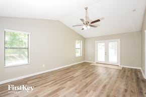 Palm Bay house for rent - a living room with hardwood floors and a ceiling fan