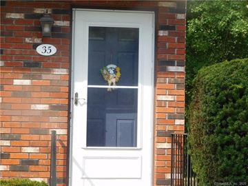 Enfield apartment for rent - the front door of a brick house with a white door