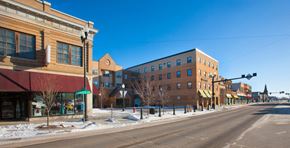 Wahpeton apartment for rent - A street view of a town with buildings on both sides and a clear blue sky.