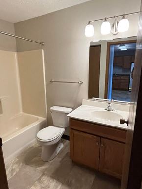 Wahpeton apartment for rent - A white toilet sits next to a sink in a bathroom.