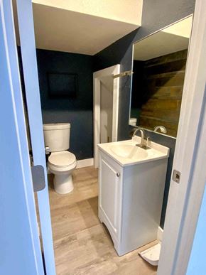 Anchorage apartment for rent - a bathroom with a toilet and a sink and a mirror