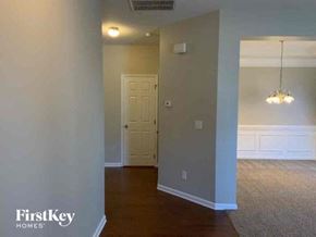 Indian Trail house for rent - an empty living room with a door and a chandelier