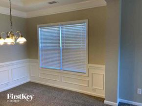 Indian Trail house for rent - a bedroom with a large window and white walls