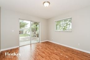 Cape Coral house for rent - a living room with a hardwood floor and a sliding glass door