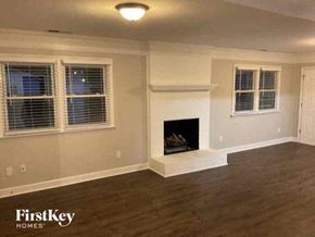 Charlotte house for rent - a living room with a fireplace and a wooden floor